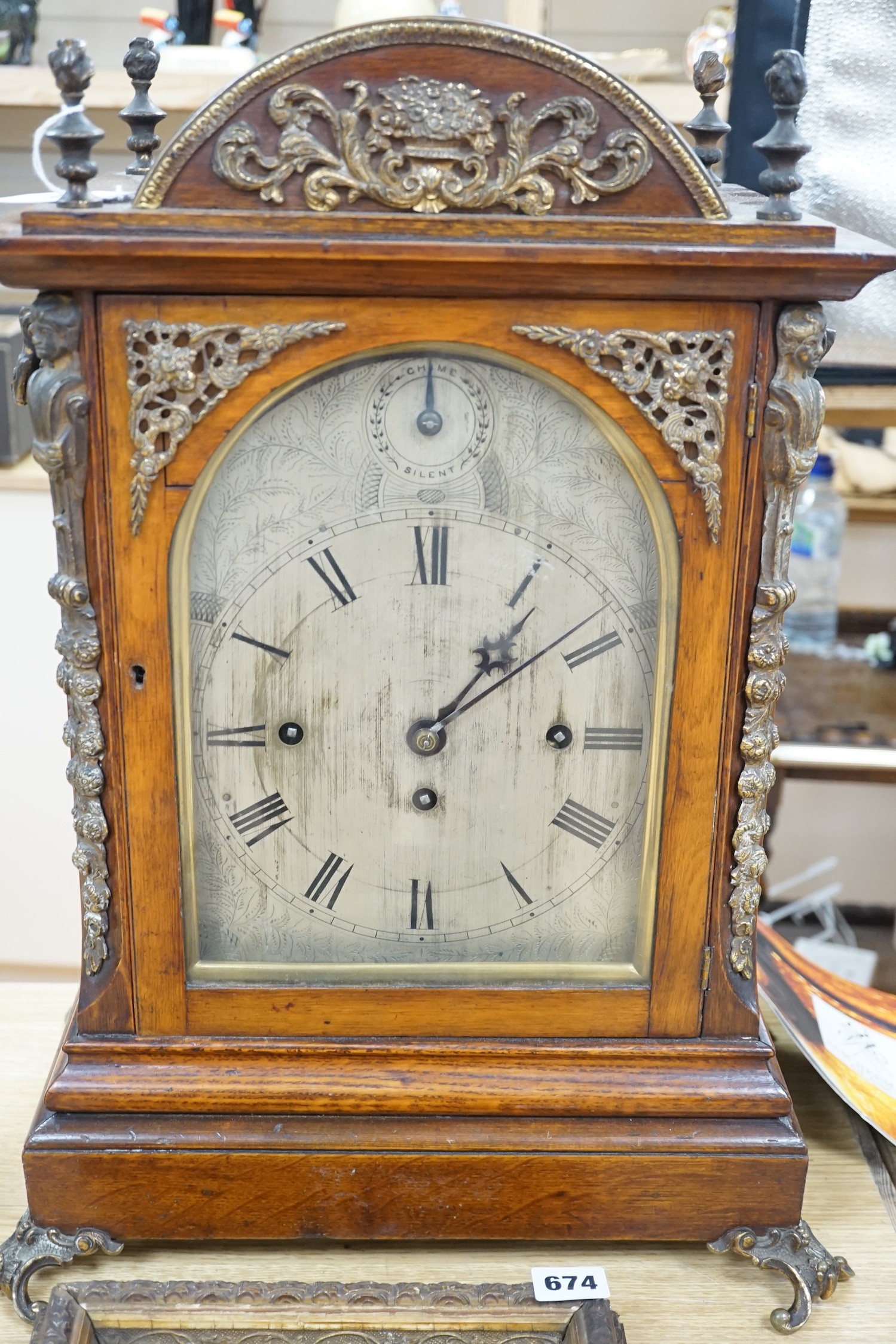 A late Victorian oak bracket clock with brass mounts and chiming movement, 55cms high